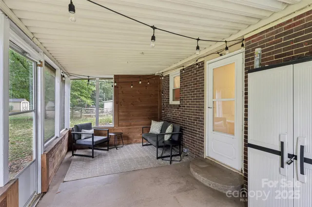 a balcony with furniture and a gate
