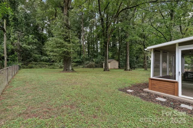 a view of a backyard with large trees
