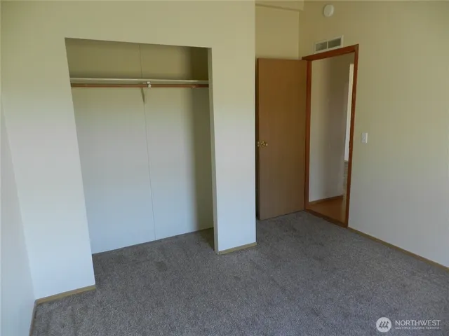 a view of a white house with a yard