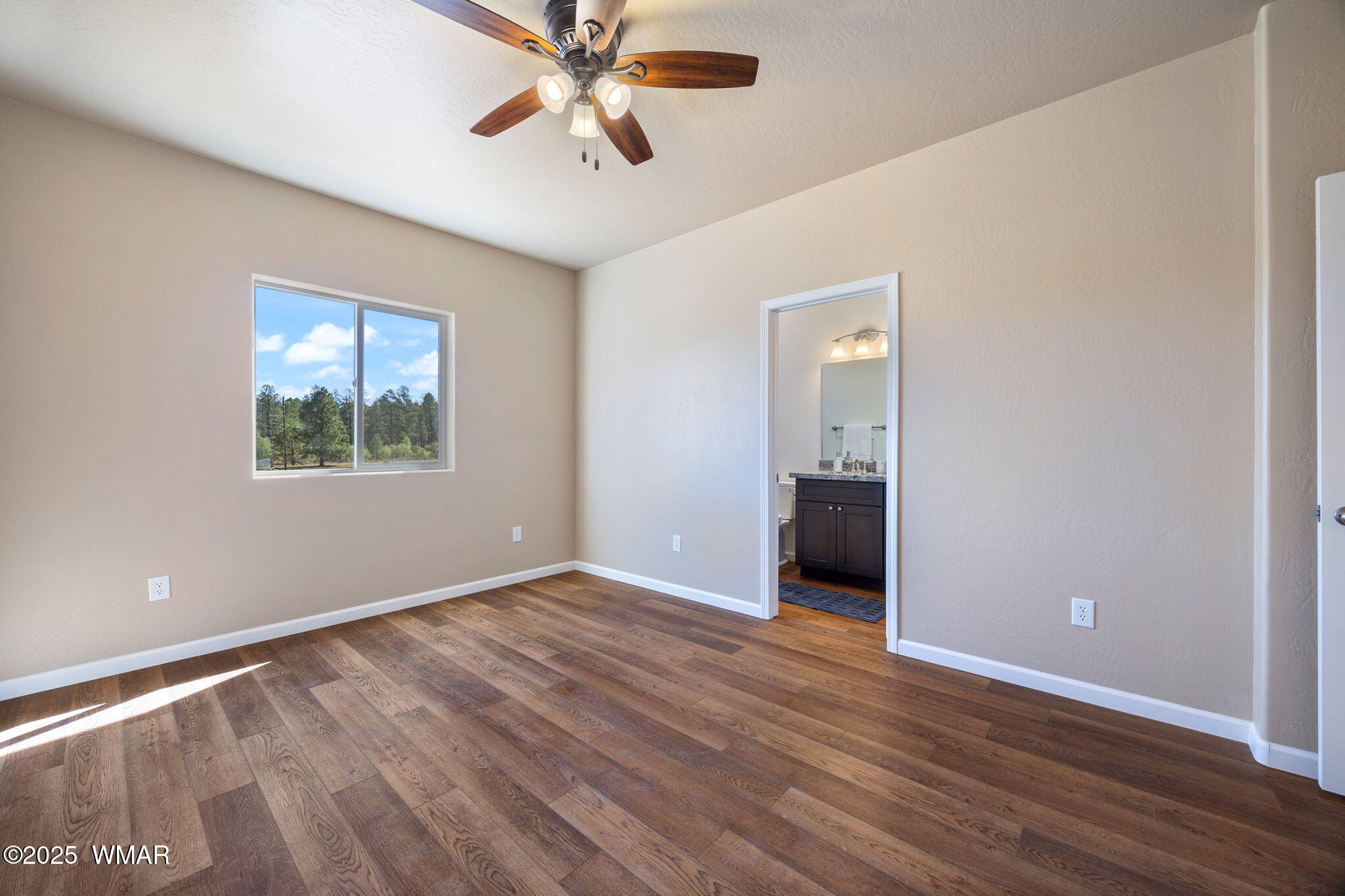 5523 Turkey Run Road Pinedale, AZ 85934 - Photo 12 of 34 an empty room with wooden floor chandelier and windows