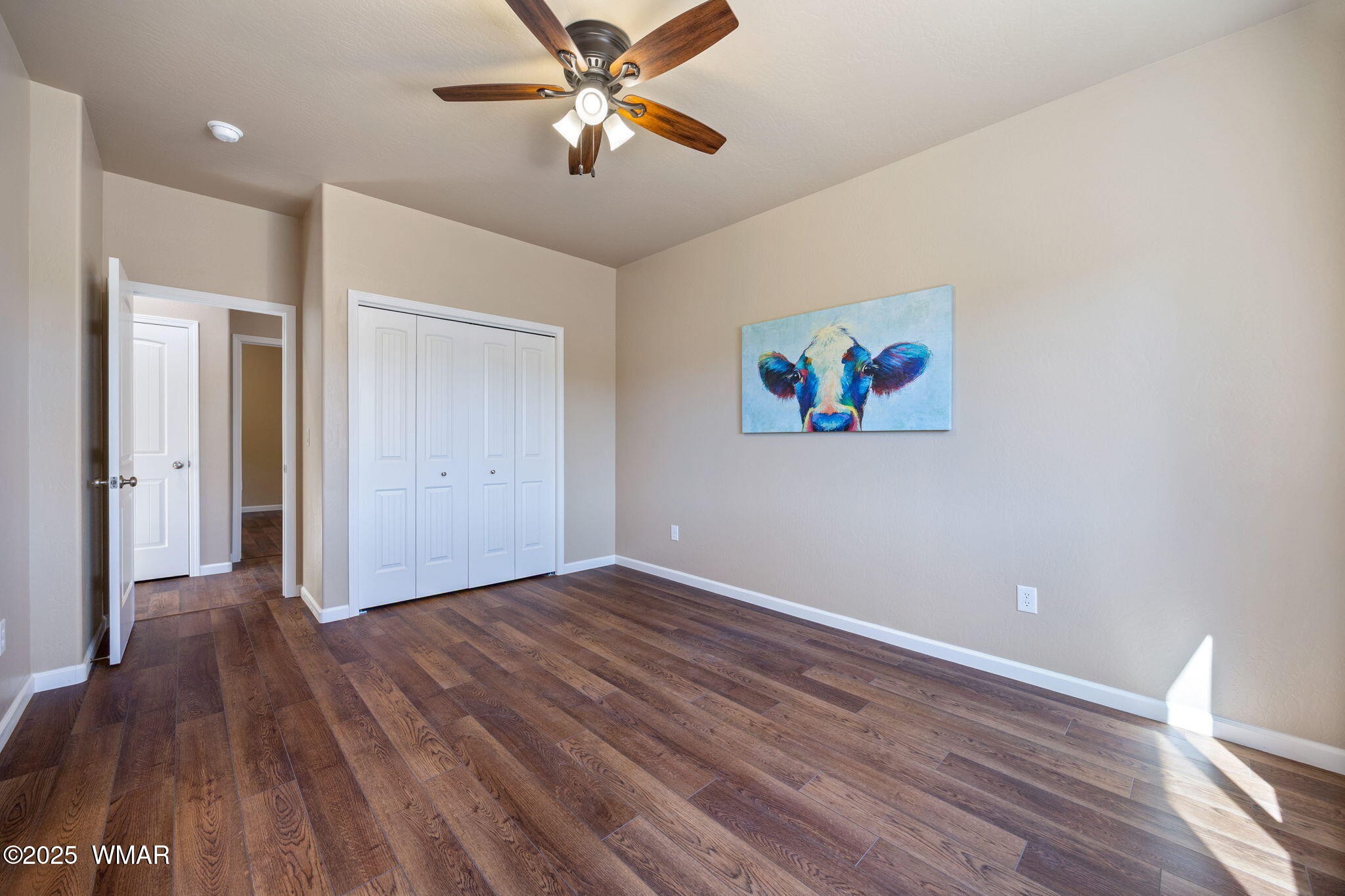 5523 Turkey Run Road Pinedale, AZ 85934 - Photo 13 of 34 an empty room with wooden floor chandelier fan and windows