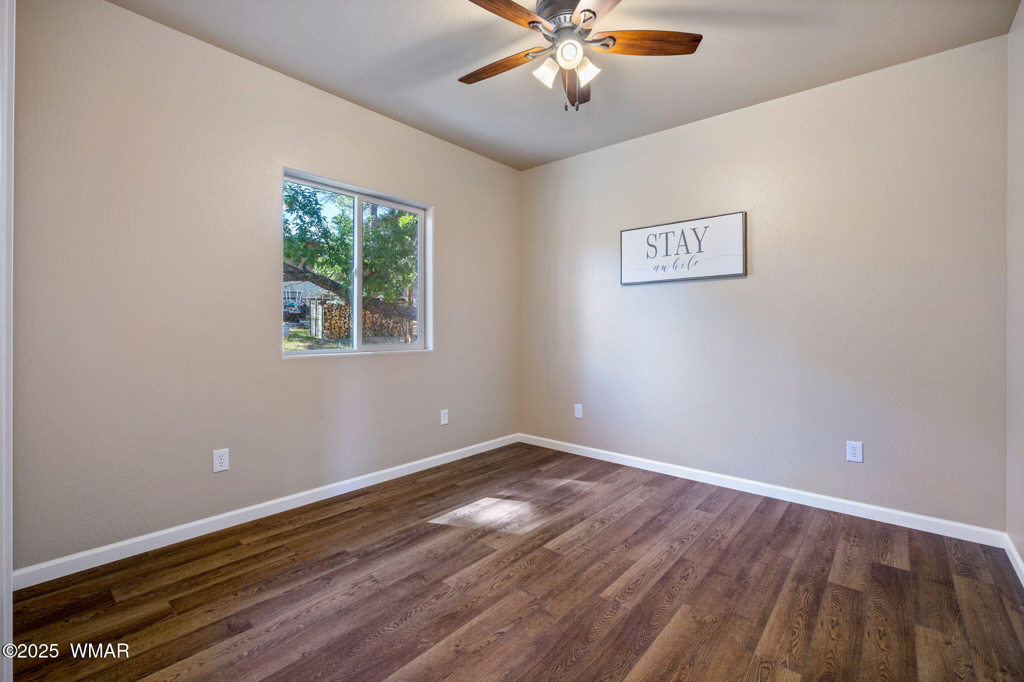5523 Turkey Run Road Pinedale, AZ 85934 - Photo 17 of 34 a view of an empty room with wooden floor and a window