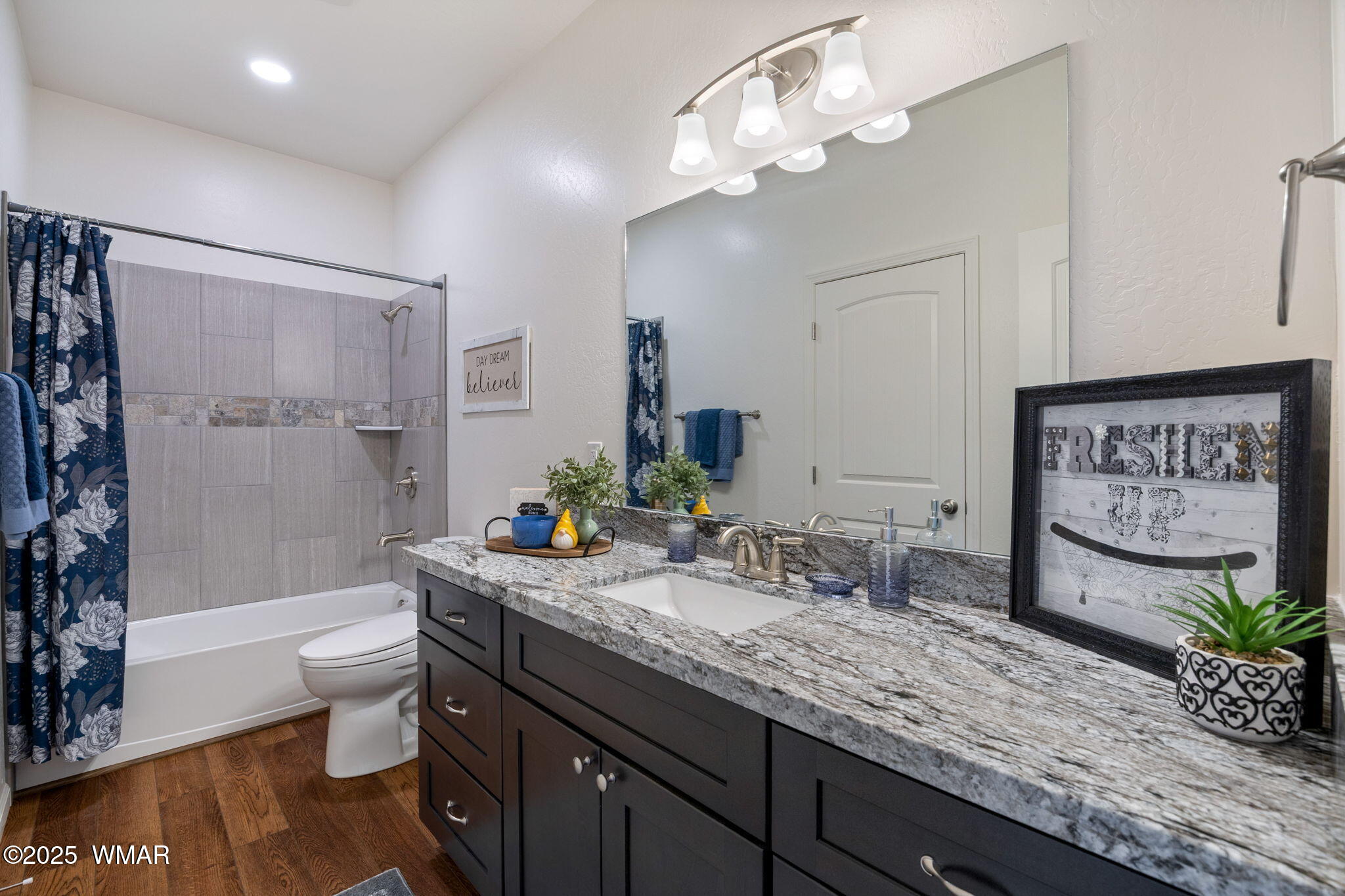5523 Turkey Run Road Pinedale, AZ 85934 - Photo 19 of 34 a bathroom with a granite countertop sink a toilet a mirror a vanity and shower
