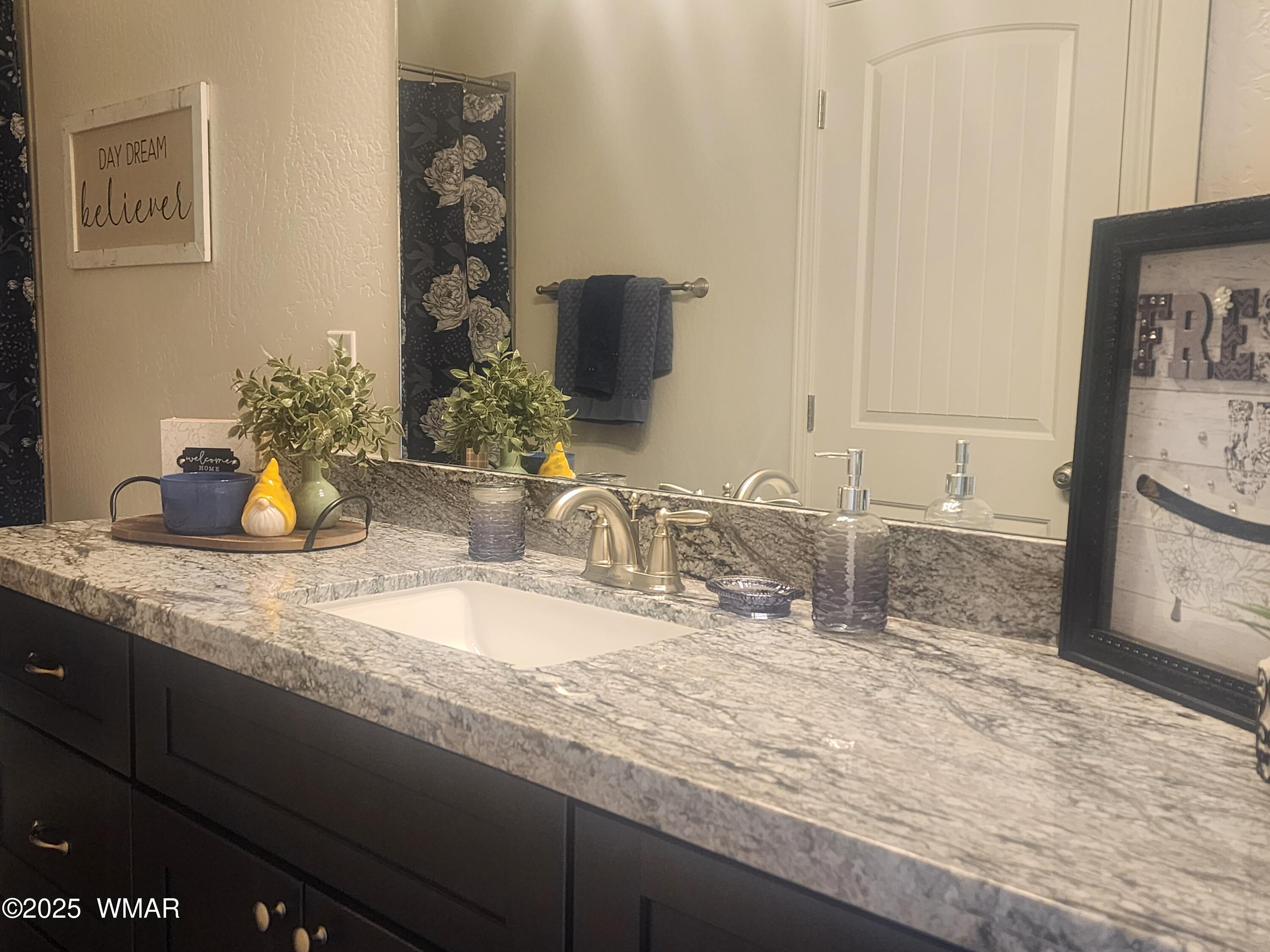 5523 Turkey Run Road Pinedale, AZ 85934 - Photo 20 of 34 a bathroom with a granite countertop sink and a mirror