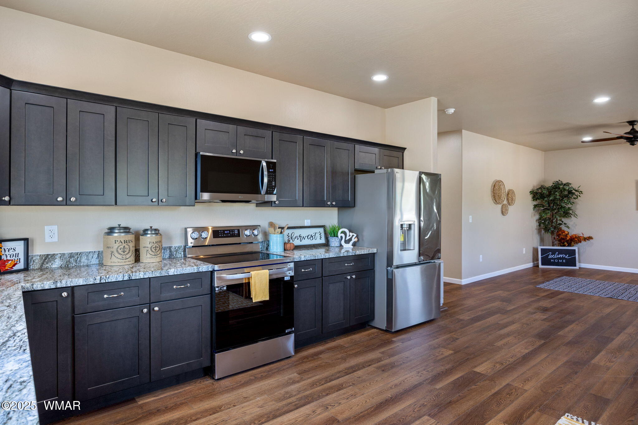 5523 Turkey Run Road Pinedale, AZ 85934 - Photo 9 of 34 a kitchen with stainless steel appliances granite countertop a refrigerator a stove top oven a sink and dishwasher with wooden floor