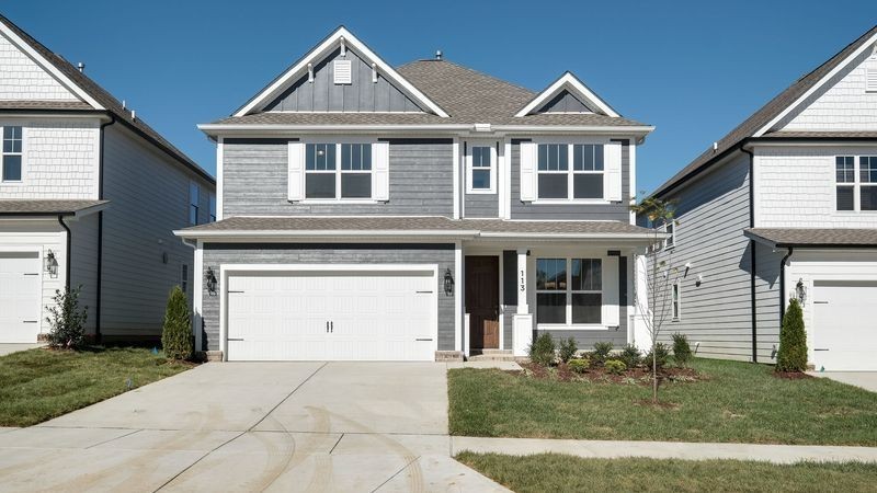 838 Sugarbush Lane Spring Hill, TN 37174 - Photo 1 of 26 a front view of a house with a yard and garage