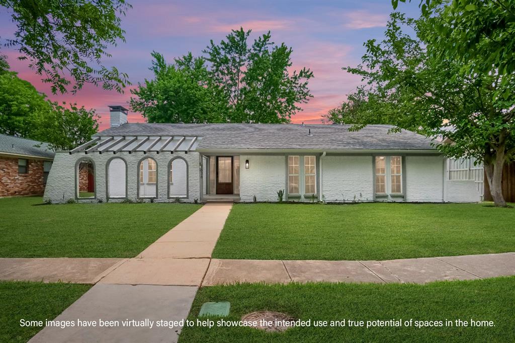 7636 La Risa Drive Dallas, TX 75248 - Photo 1 of 1 a view of a white house with a yard