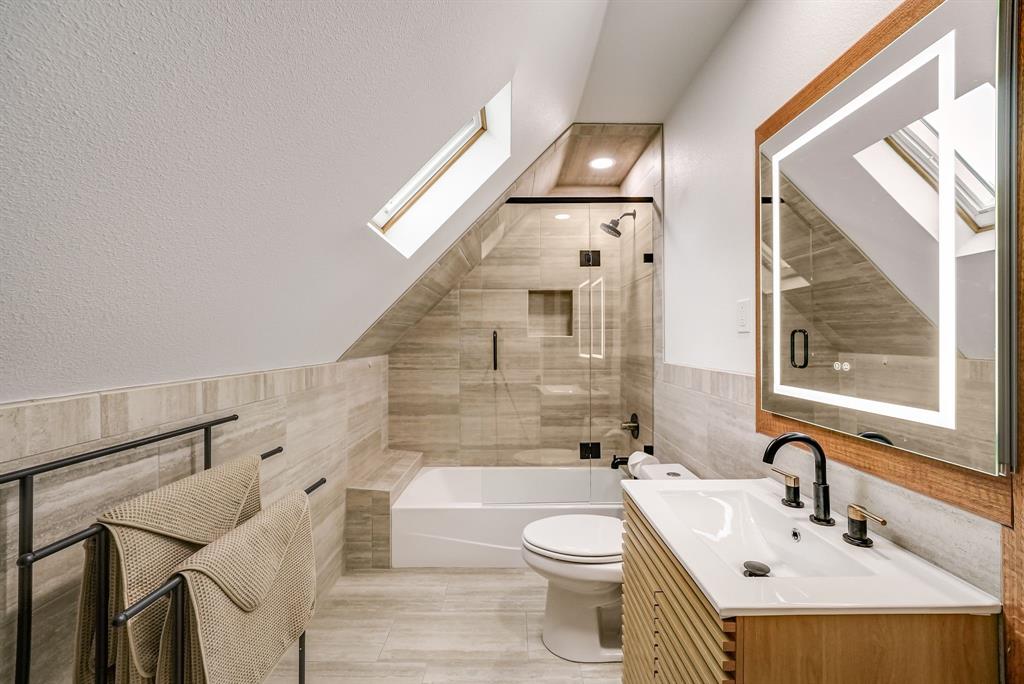 1037 Harrison Road Denison, TX 75021 - Photo 26 of 39 Ensuite Full Bathroom#2 (Sits off of Room #3) featuring a skylight, tile flooring, and a walk-in shower with glass enclosure