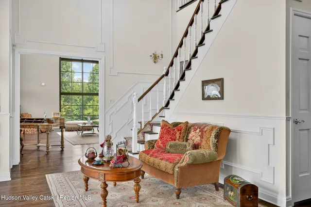 a living room with furniture fireplace and a large window