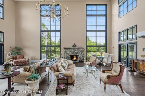 a living room with furniture kitchen view and a large window