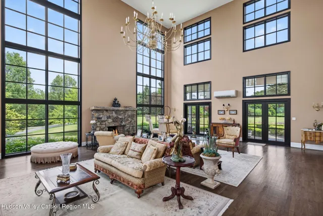 a living room with furniture and a large window with outer view