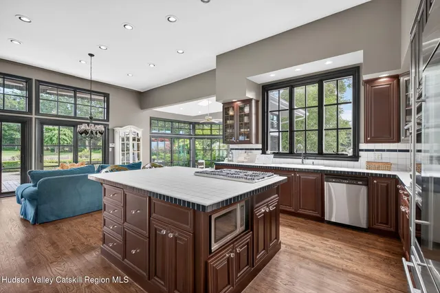 a bedroom with a balcony a bed and a chandelier