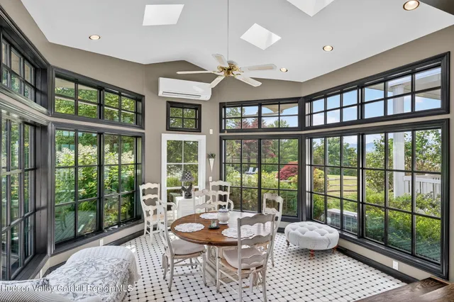a white table sitting in a living room next to a window