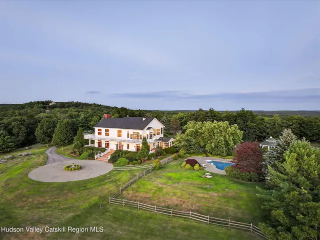 a view of a house with a yard and sitting area