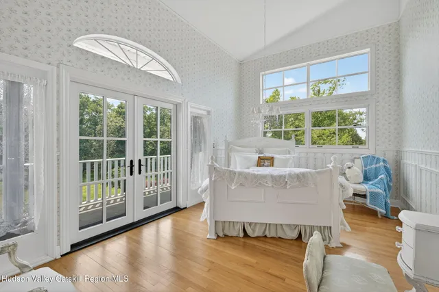a bedroom with a bed and a large window