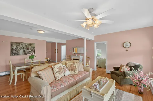 a view of a workspace with furniture and a window