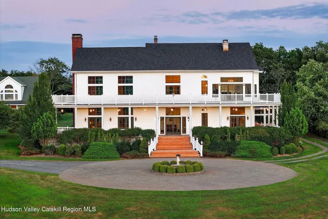 a view of a porch with furniture and wooden floor