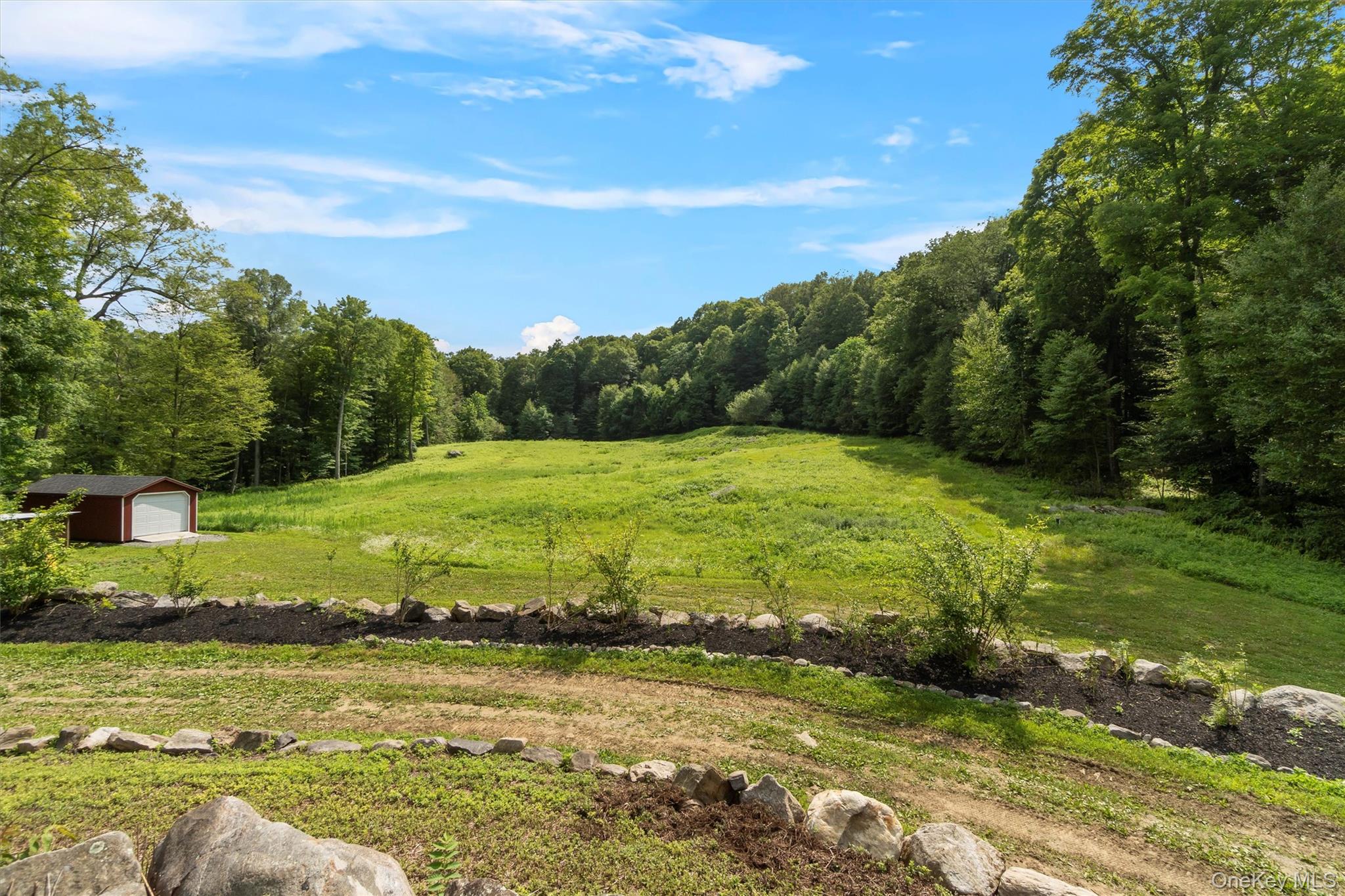 1081 East Mountain Road South Cold Spring, NY 10516 - Photo 46 of 50 Stone walls driveway leading to back patio. See special feature sheet for outbuildings: garage, tool shed, chicken coop, wood storage shed & Amish made rough Sawn Outhouse!