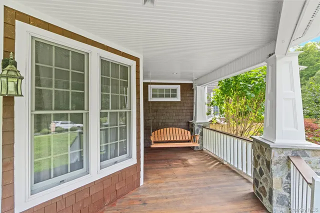a view of a room with wooden floor and iron stairs