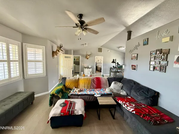 a living room with furniture and wooden floor