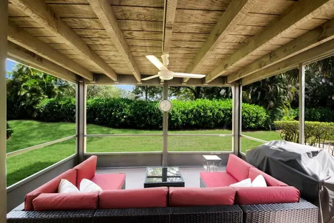 a view of a patio with a table chairs and a backyard