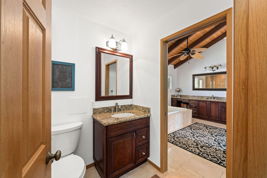 1444 East Kuiaha Road Haiku, HI 96708 - Photo 7 of 30 a bathroom with a toilet a sink and mirror