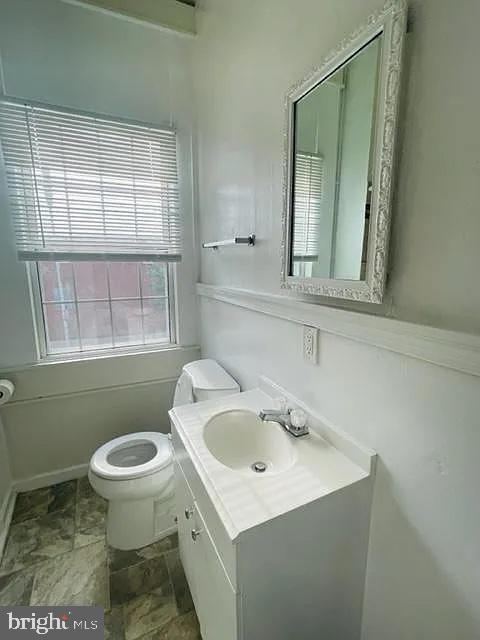 1112 North Eden Street Baltimore, MD 21213 - Photo 12 of 16 a bathroom with a sink a toilet and a window