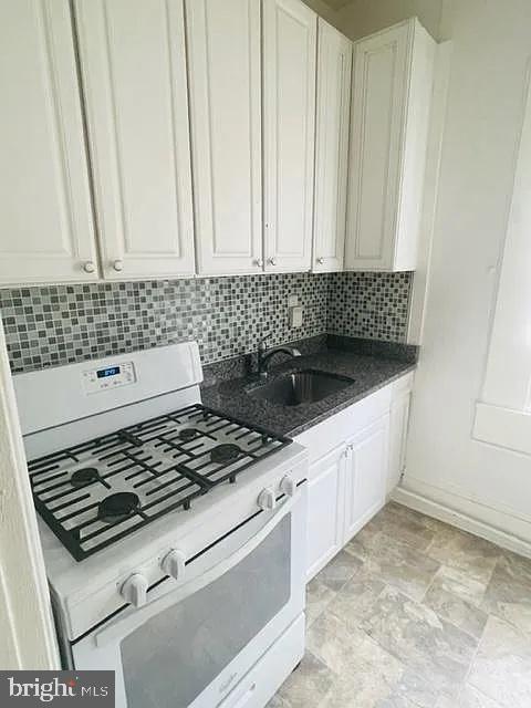 1112 North Eden Street Baltimore, MD 21213 - Photo 13 of 16 a kitchen with a stove and a sink