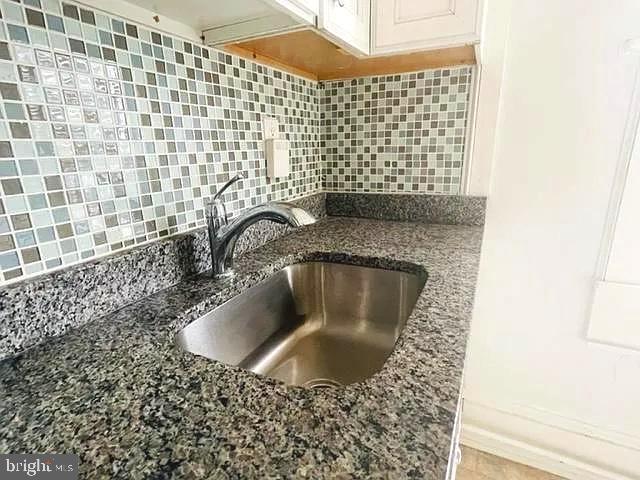 1112 North Eden Street Baltimore, MD 21213 - Photo 3 of 16 a bathroom with a sink and granite
