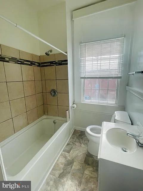 1112 North Eden Street Baltimore, MD 21213 - Photo 4 of 16 a bathroom with a sink a toilet and shower