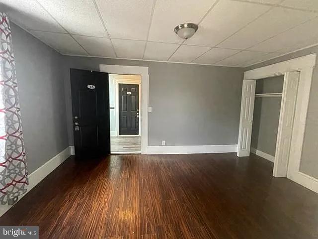 1112 North Eden Street Baltimore, MD 21213 - Photo 8 of 16 an empty room with wooden floor and windows