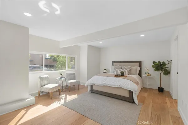 a bedroom with a large bed and a large window