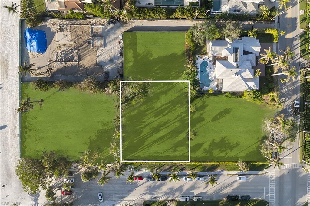 45 5th Avenue South Naples, FL 34102 - Photo 2 of 3 a green field with trees in the background