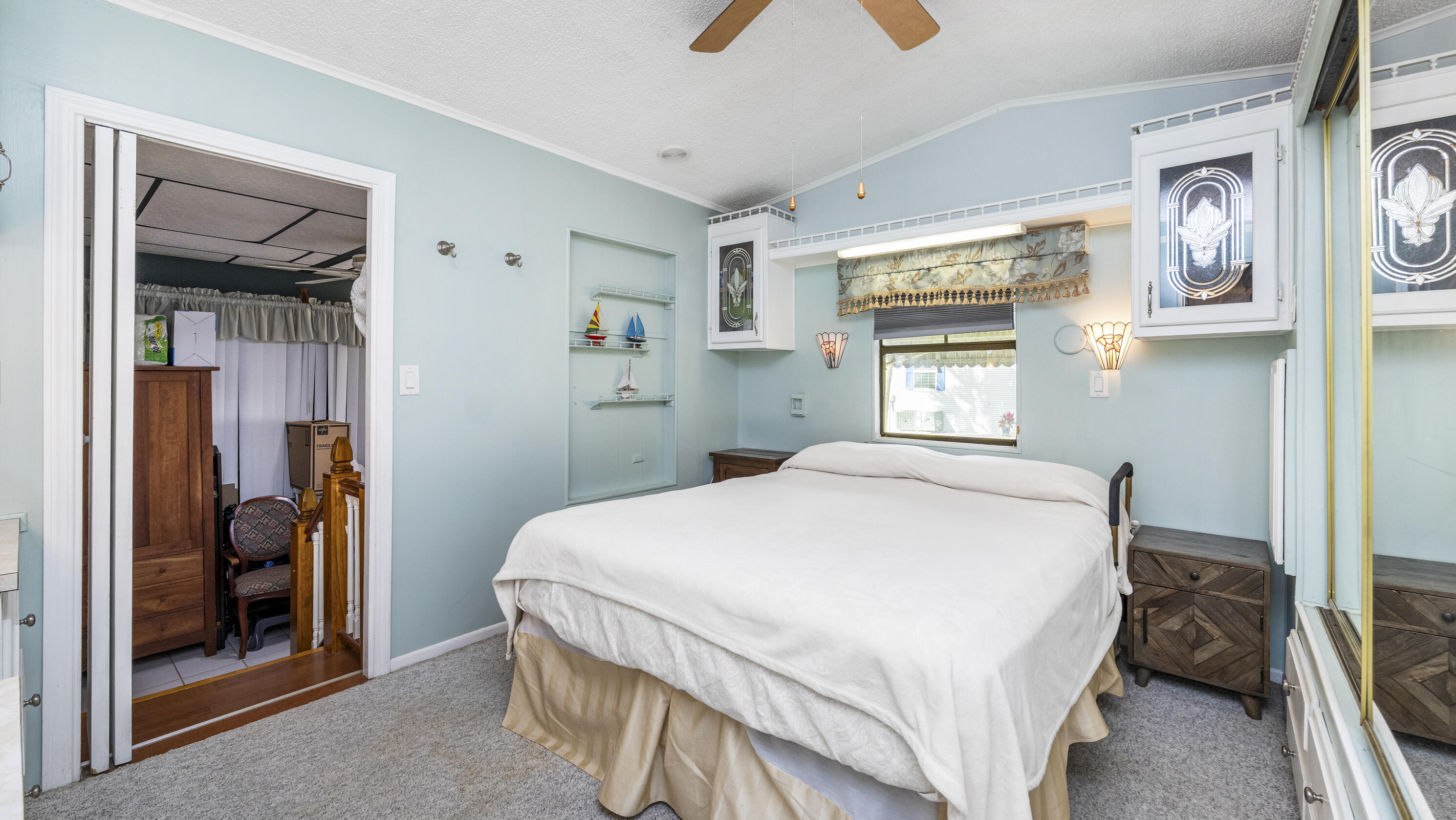 186 Panther Pass Circle Naples, FL 34114 - Photo 18 of 40 a bedroom with a bed and a mirror