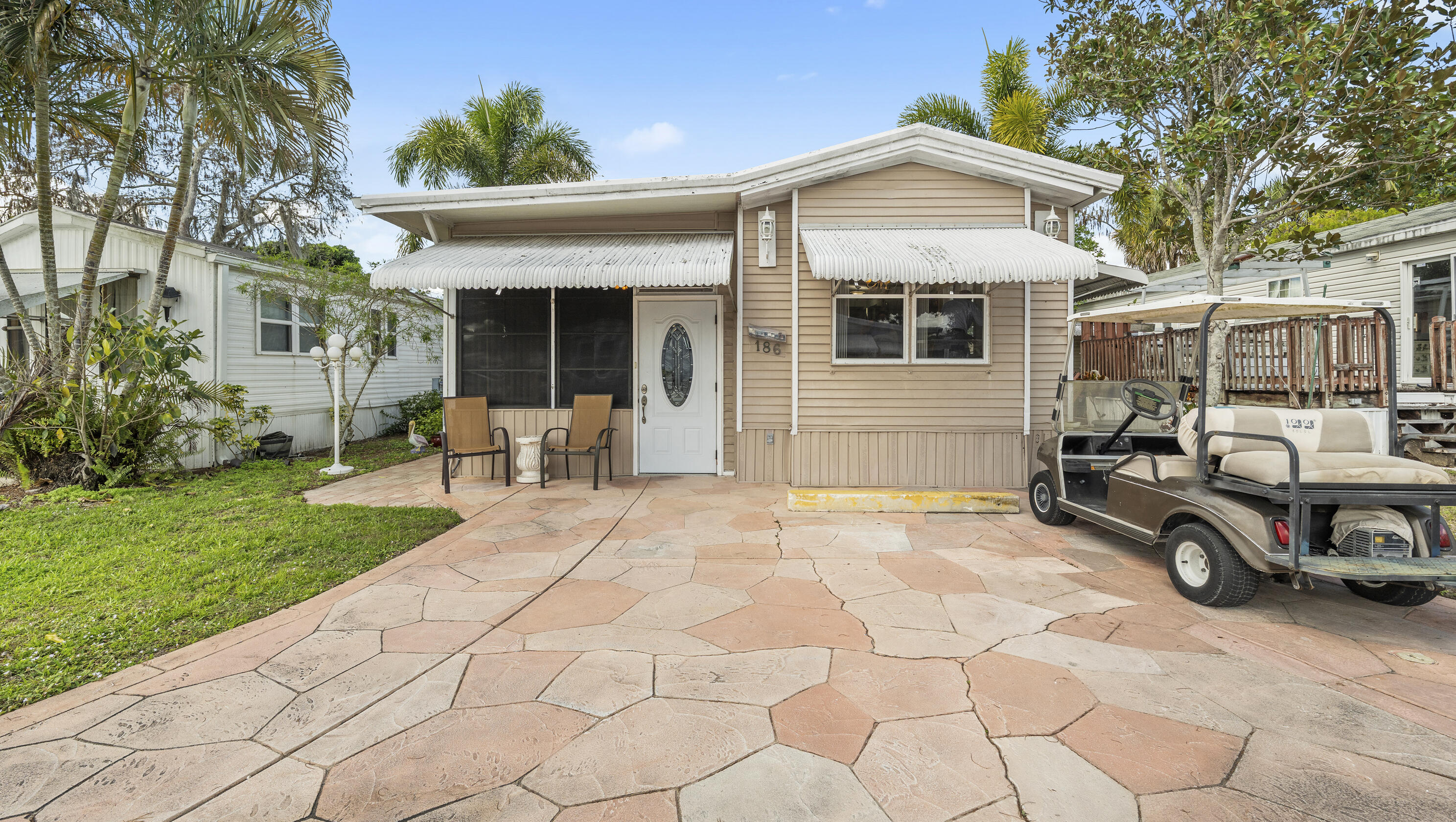 186 Panther Pass Circle Naples, FL 34114 - Photo 2 of 40 a front view of a house with garden