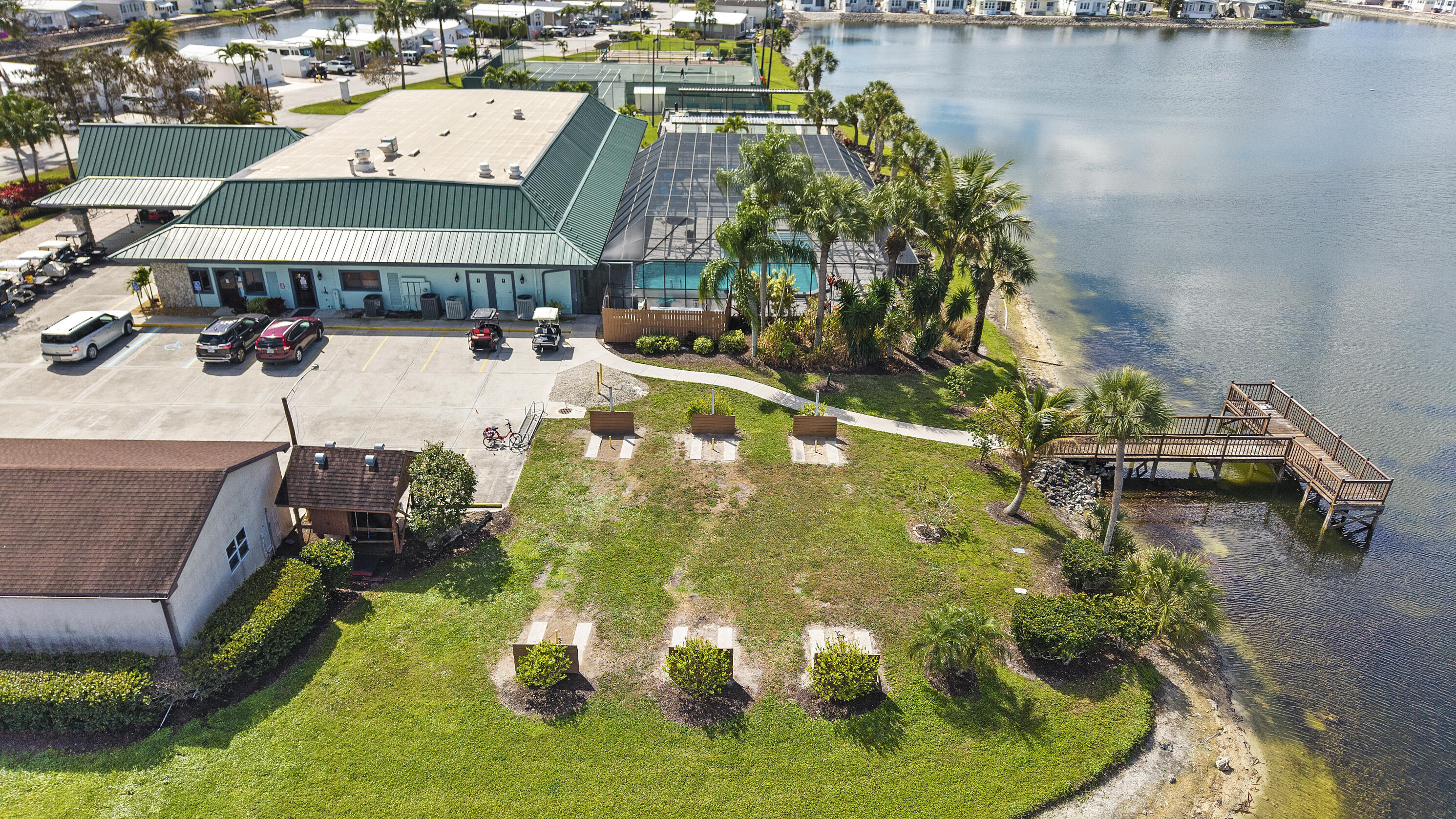 186 Panther Pass Circle Naples, FL 34114 - Photo 29 of 40 an aerial view of a house with swimming pool and lake view