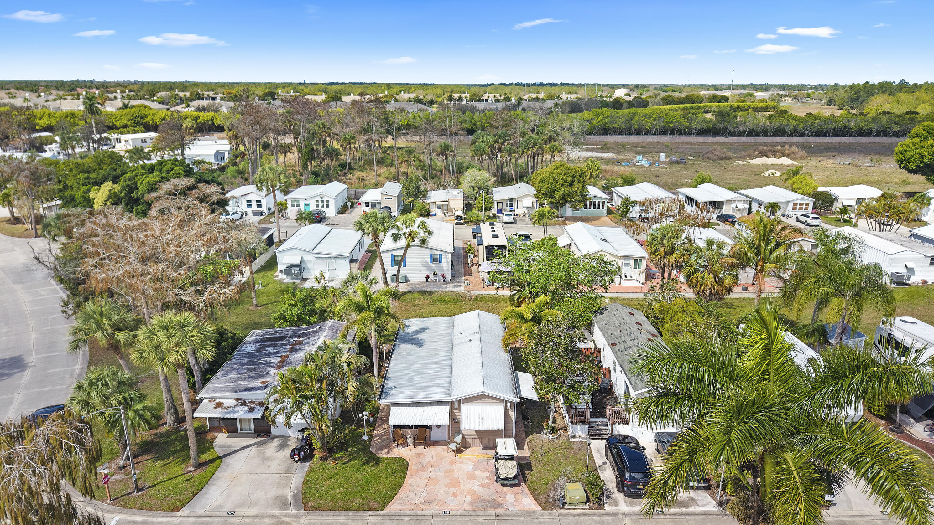 186 Panther Pass Circle Naples, FL 34114 - Photo 39 of 40 an aerial view of residential houses with outdoor space and lake view