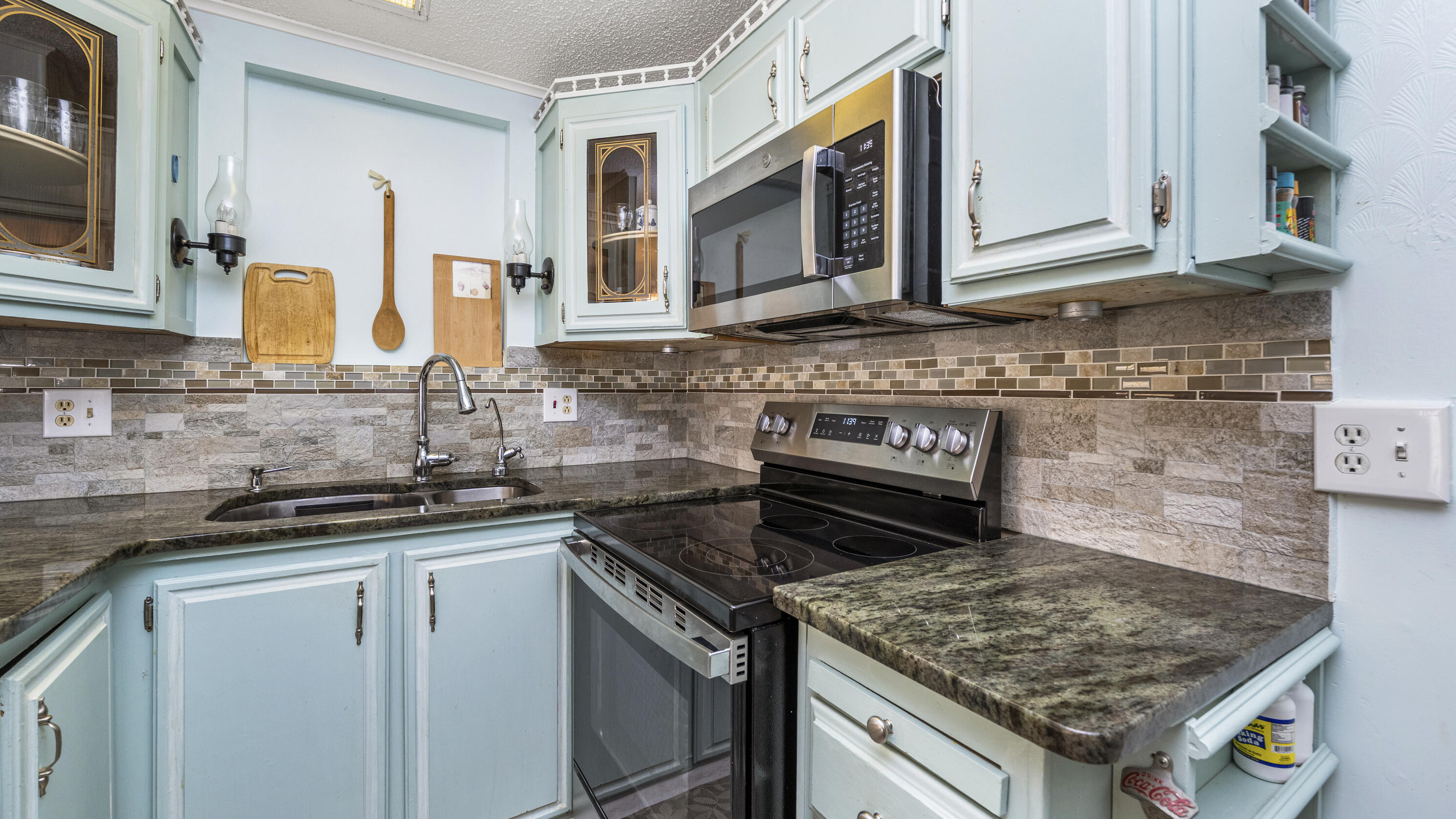 186 Panther Pass Circle Naples, FL 34114 - Photo 5 of 40 a kitchen with stainless steel appliances granite countertop a stove sink and cabinets