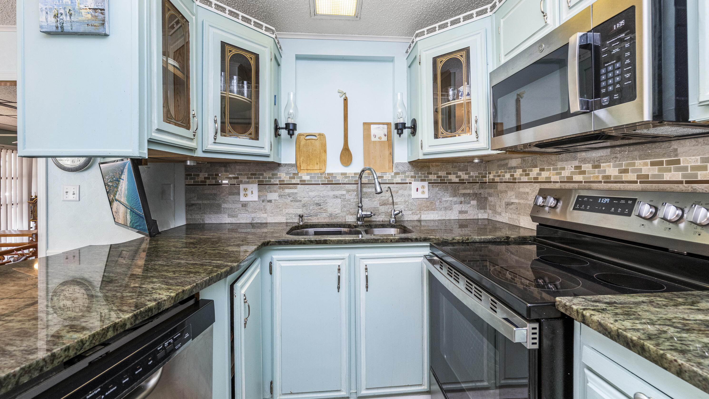 186 Panther Pass Circle Naples, FL 34114 - Photo 6 of 40 a kitchen with stainless steel appliances granite countertop a stove and a sink