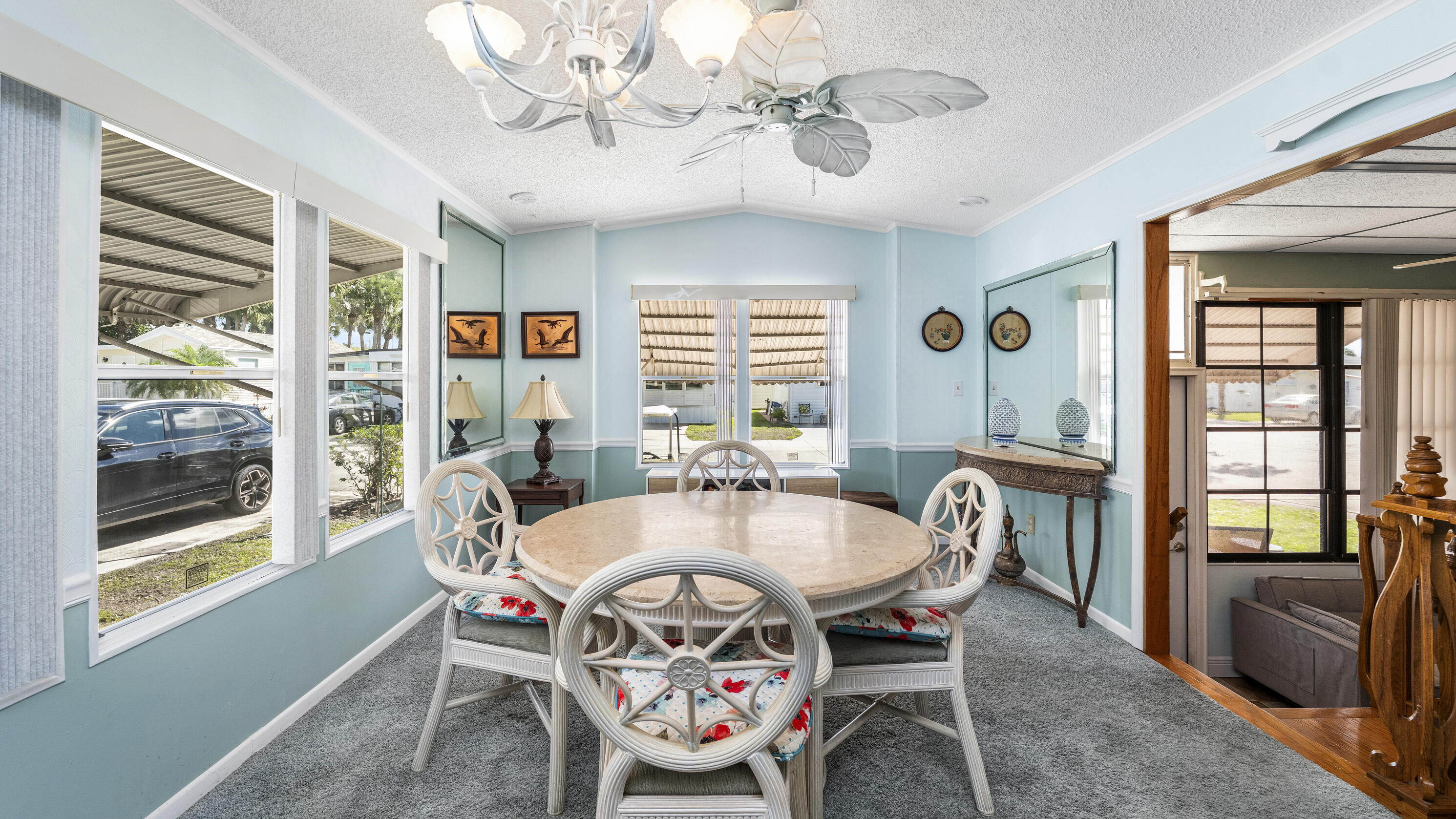 186 Panther Pass Circle Naples, FL 34114 - Photo 8 of 40 a dining room with furniture a chandelier and wooden floor