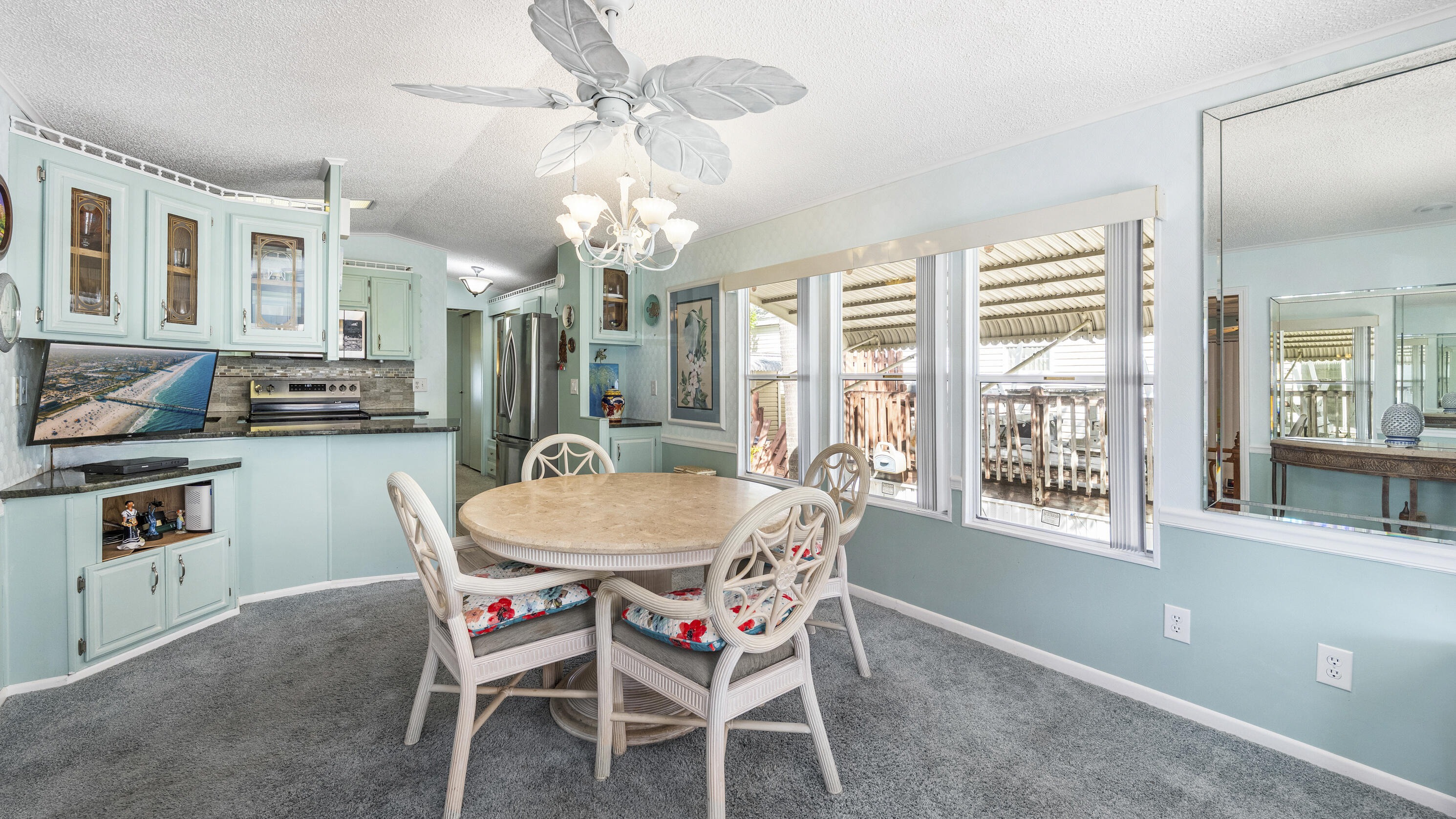 186 Panther Pass Circle Naples, FL 34114 - Photo 10 of 40 a dining room with furniture a chandelier and a rug