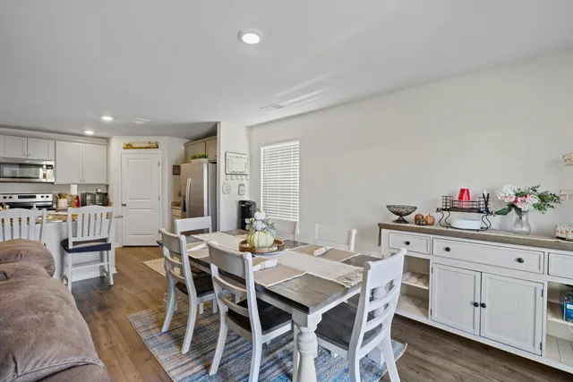 a view of a dining room with furniture and a window
