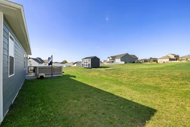 a front view of a house with yard and garage