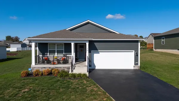 a view of a house with backyard porch and sitting area