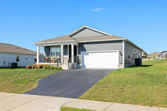 a view of a house with a yard and garage