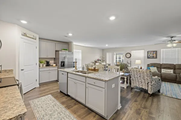 a kitchen with white cabinets and sink