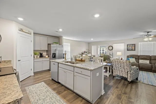 a kitchen with white cabinets and sink