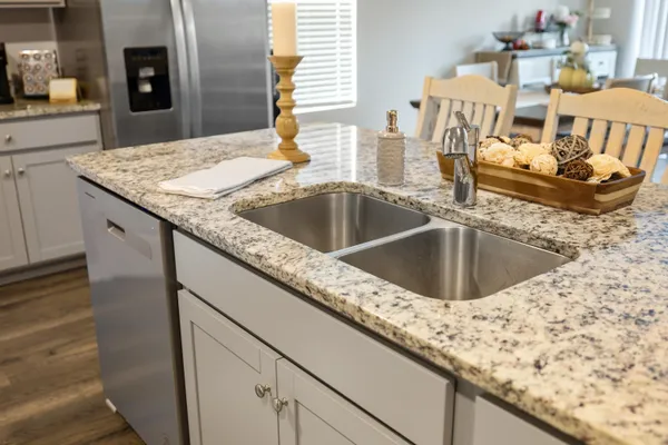 a kitchen with sink and granite