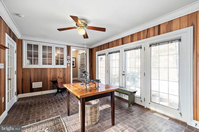 a backyard of a house with a large tree table and chairs