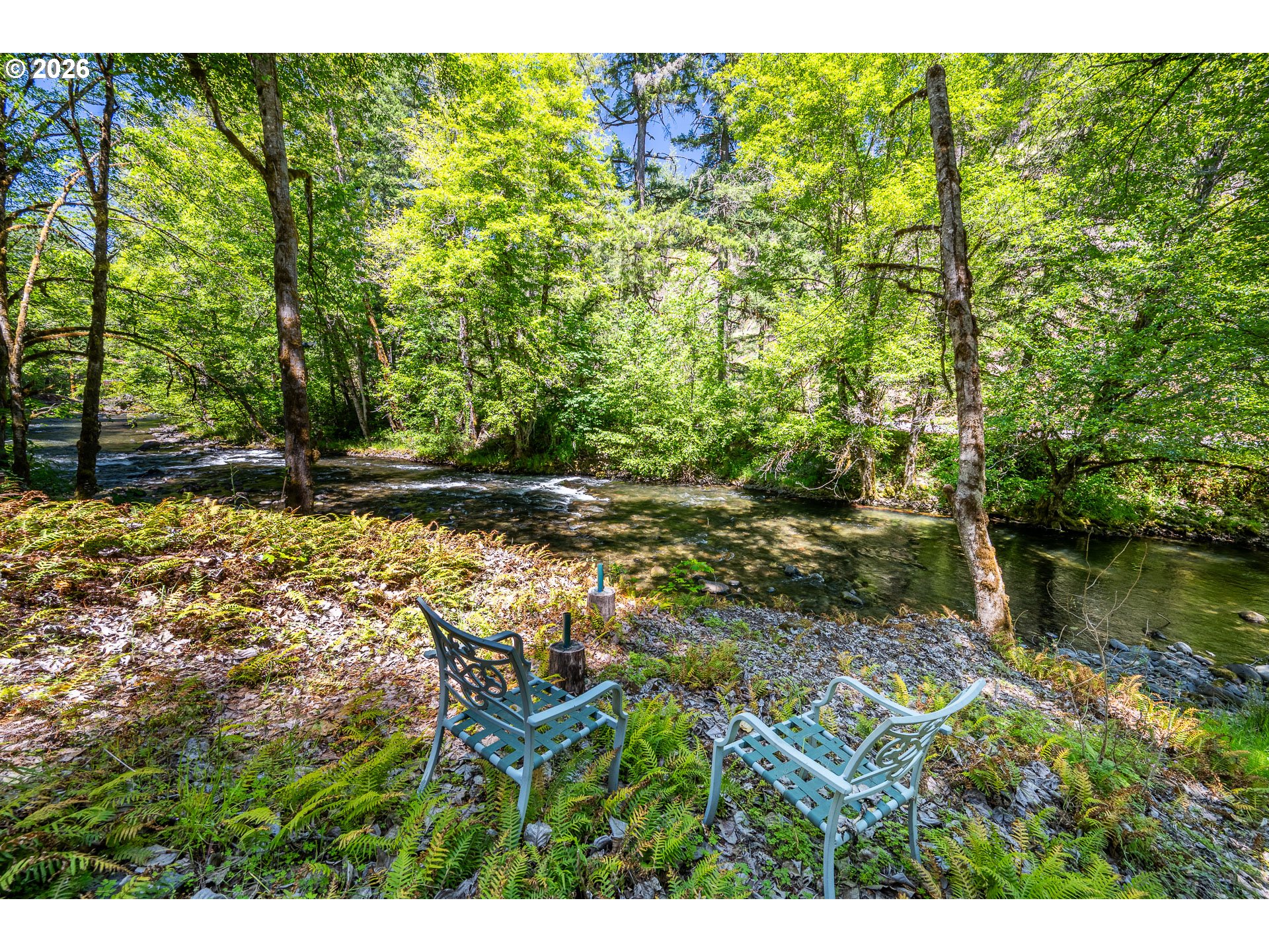 49091 Salt Creek Road Oakridge, OR 97463 - Photo 6 of 16 a backyard of a house with a yard and outdoor seating